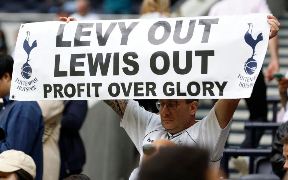 A Tottenham Hotspur fan displays a banner in protest against owner Joe Lewis and chairman Daniel Levy - Action Images/Peter Cziborra