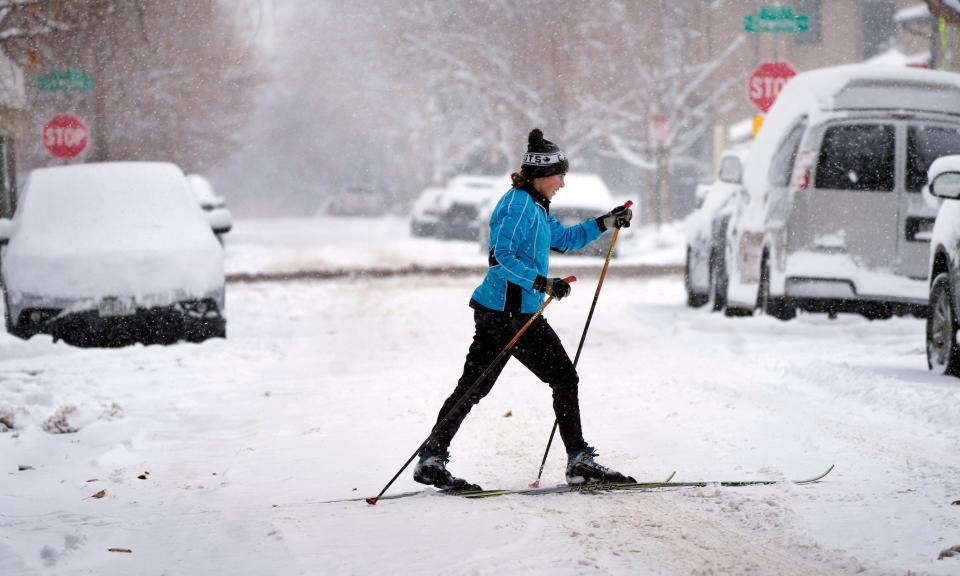 A cross-country skier navigates Dakota Street along Marion Parkway after a winter storm packing heavy snow enveloped the intermountain West, Wednesday, Jan. 18, 2023, in Denver.