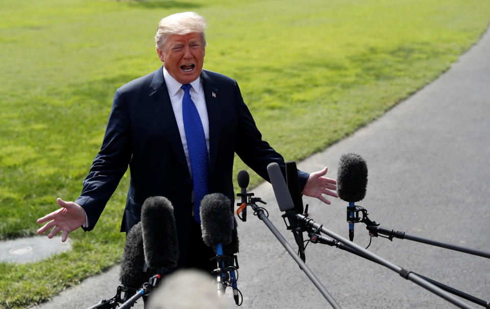 Trump talks to reporters on the White House lawn on Oct. 2, 2018, before boarding the Marine One helicopter for a trip to Pennsylvania and Tennessee. (Photo: Leah Mills/Reuters)