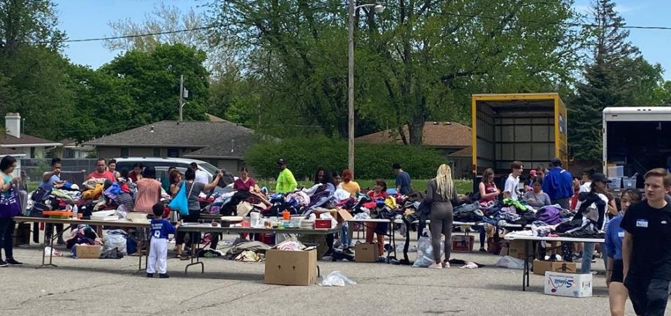 Families comb through donations at a spring free store held for refugees and immigrants by Des Moines Refugee Support.