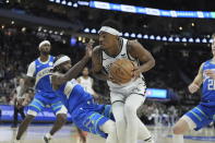 Brooklyn Nets' Nic Claxton is called for a charge on Milwaukee Bucks' Patrick Beverley during the first half of an NBA basketball game Thursday, March 21, 2024, in Milwaukee. (AP Photo/Morry Gash)