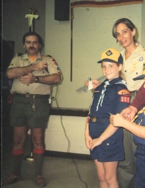 A young Margo Mankes, in Cub Scouts uniform, with her parents