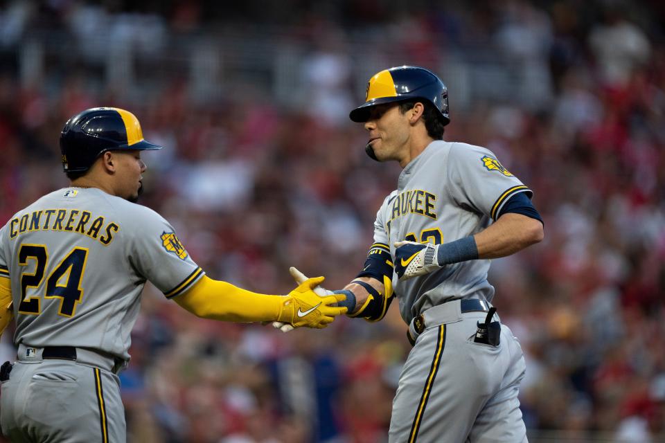 Christian Yelich celebrates with Brewers catcher William Contreras after Yelich hit a home run to open Saturday's game at Great American Ball Park.