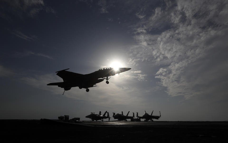 FILE - In this file picture taken on Monday, Nov. 21, 2016, a U.S. Navy fighter jet lands on the deck of the U.S.S. Dwight D. Eisenhower aircraft carrier. The carrier is currently deployed in the Persian Gulf, supporting Operation Inherent Resolve, the military operation against Islamic State extremists in Syria and Iraq. A spokesman for the U.S.-led coalition said Friday, Jan. 11, 2019 that the process of withdrawal in Syria has begun, declining to comment on specific timetables or movements. (AP Photo/Petr David Josek, File)