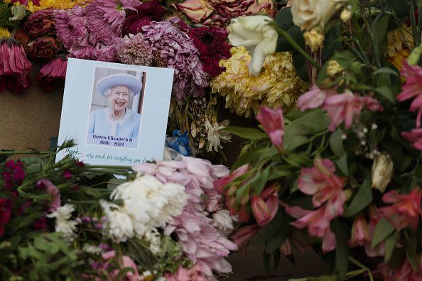 HULL, ENGLAND - SEPTEMBER 19: Floral tributes as the funeral of Her Majesty Queen Elizabeth II is screened at Hull City Hall on September 19, 2022 in Hull, United Kingdom. Elizabeth Alexandra Mary Windsor was born in Bruton Street, Mayfair, London on 21 April 1926. She married Prince Philip in 1947 and acceded to the throne of the United Kingdom and Commonwealth on 6 February 1952 after the death of her Father, King George VI. Queen Elizabeth II died at Balmoral Castle in Scotland on September 8, 2022, and is succeeded by her eldest son, King Charles III. (Photo by Nigel Roddis/Getty Images)