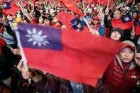 FILE PHOTO: Supporters of Kuomintang party's presidential candidate Han Kuo-yu wave Taiwanese flags during an election rally in Taipei