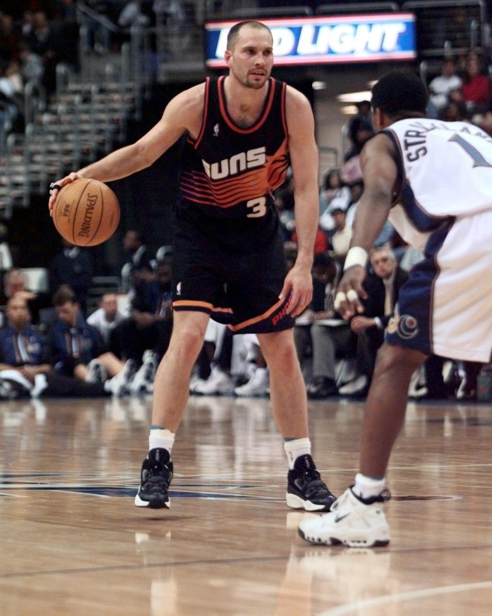 Suns guard Rex Chapman dribbles against Rod Strickland of the Washington Wizards during the 1997-98 season.