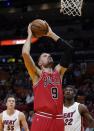 Chicago Bulls center Nikola Vucevic prepares to dunk next to Miami Heat forward Jimmy Butler (22) and guard Duncan Robinson (55) during the first half of an NBA basketball game Monday, Feb. 28, 2022, in Miami. (AP Photo/Marta Lavandier)