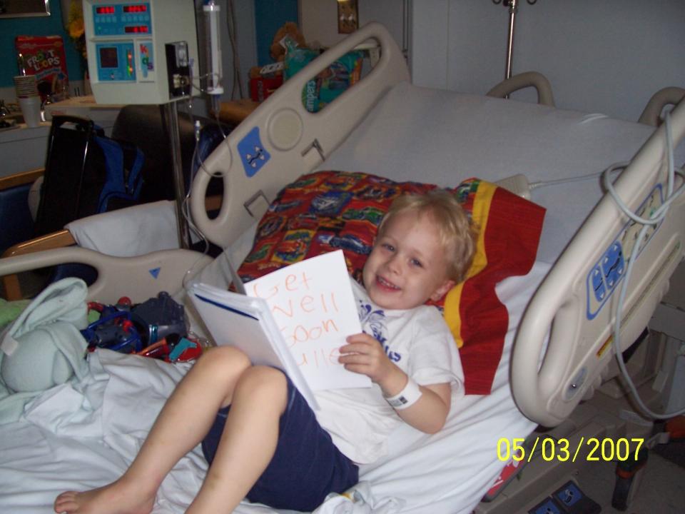 Fuller smiles in his hospital bed and reads a get well soon card shortly after he was diagnosed with cancer (Photo courtesy of Melissa Goldsmith)