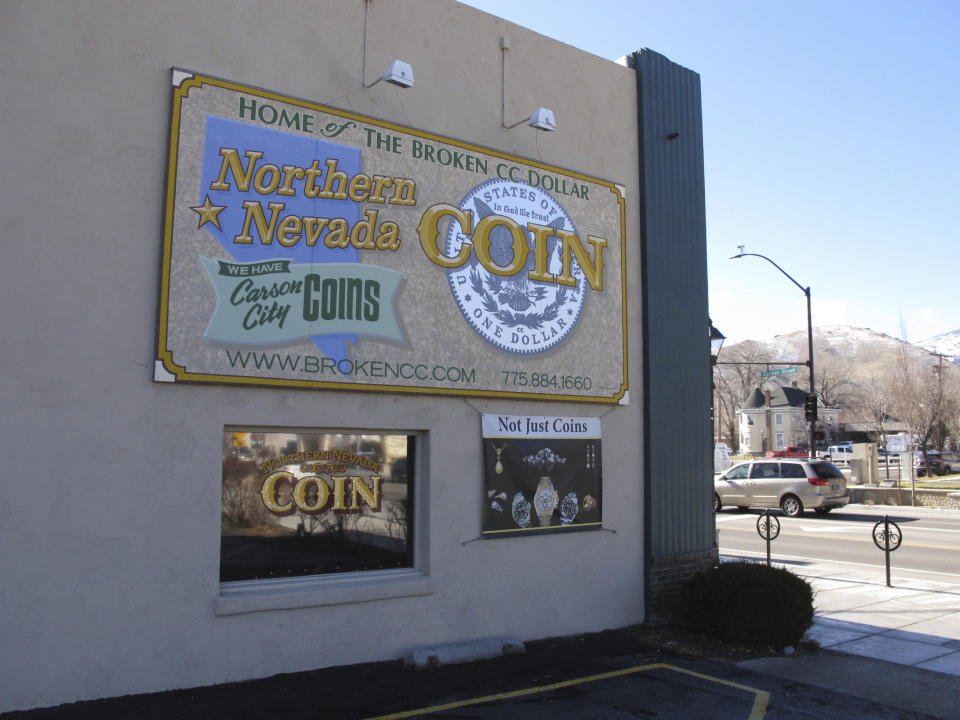 Traffic passes along North Carson Street in Carson City, Nev., outside Northern Nevada Coin, Thursday, Jan. 24, 2019. Store owner Allen Rowe says he bought items earlier this month from a man suspected in a string of four homicides. Rowe says Wilbur Martinez-Guzman, of El Salvador, used his passport as identification to sell jewelry that investigators say were stolen from two victims. (AP Photo/Scott Sonner)