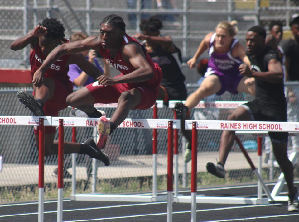 Raines teammates Reshawn Latimer (left) and Harrison Robinson clear the hurdles during the boys 110-meter hurdles  at the District 3-3A Florida High School Athletic Association championship on April 23, 2022. [Clayton Freeman/Florida Times-Union]