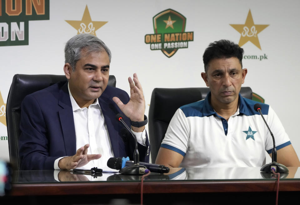 Pakistan Cricket Board Chairman Mohsin Naqvi, in blue coat, left, with newly appointed Assistant Coach for Pakistan Cricket team Azhar Mahmood, speaks during a news conference in Lahore, Pakistan, Sunday, April 28, 2024. The Pakistan Cricket Board has appointed Gary Kirsten and Jason Gillespie to two-year terms as head coaches in white-ball and red-ball cricket, respectively, on Sunday. (AP Photo/K.M. Chaudary)