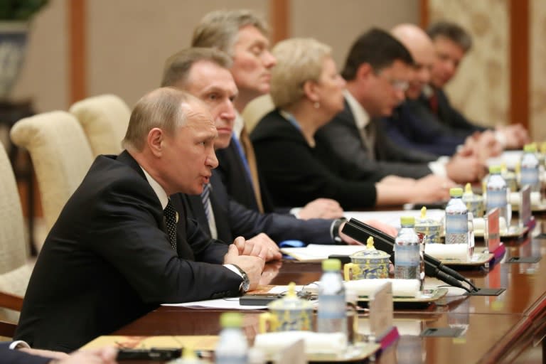 Russia's President Vladimir Putin (L) speaks with his Chinese counterpart Xi Jinping during a bilateral meeting at Diaoyutai State Guesthouse in Beijing, on May 14, 2017