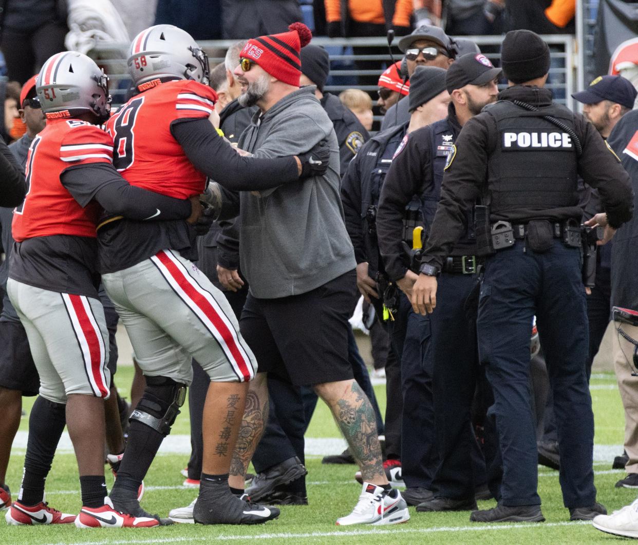 McKinley’s Mekhi Mack (58) is held back by teammate Marcel Watts during a postgame melee with Massillon players, Saturday, Oct. 21, 2023.