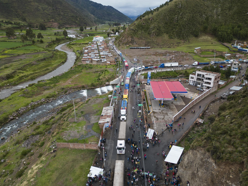 FILE - Traffic slowly make its way through a roadblock set up by Quechua Indigenous anti-government demonstrators during a respite by the protesters that temporarily allowed traffic to pass, in Sicuani, Peru, Jan. 28, 2023. Peruvians have been protesting since early December, when former President Pedro Castillo was impeached after a failed attempt to dissolve Congress. Demonstrations were first largely concentrated in the south, a region of Peru that feels a particular kinship to Castillo’s humble background as a rural teacher from the Andean highlands.(AP Photo/Rodrigo Abd, File)