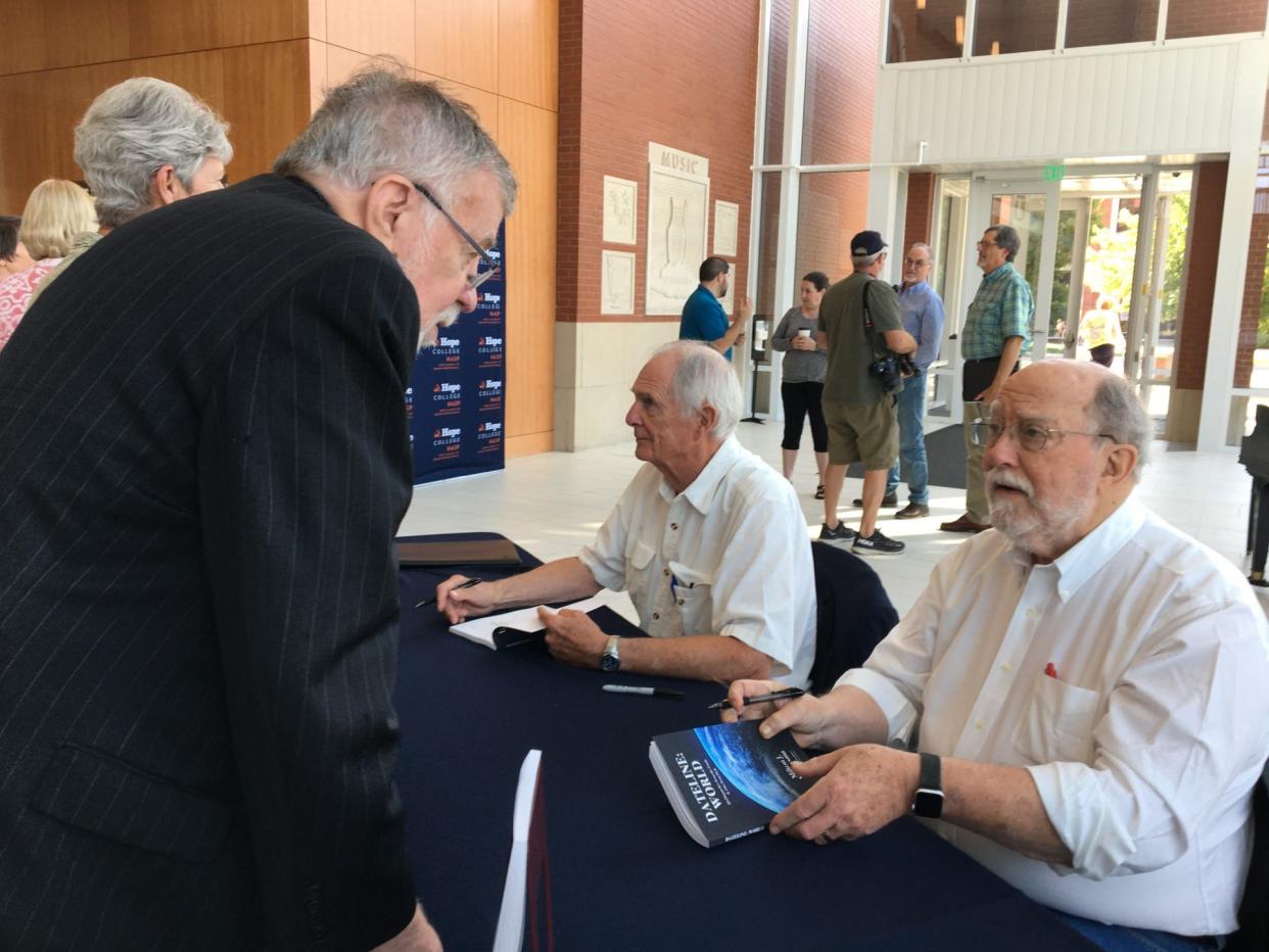 Milton Nieuwsma (center) and Tom Stites (right) sign copies of Nieuwsma's new book "Dateline: World — 20 Dispatches from the Earth & One from Hell” after a Hope Academy of Senior Professionals panel discussion on Sept. 5 at Hope College. The book is a compendium of stories Nieuwsma wrote for the Chicago Tribune and other newspapers over 40 years. Stites wrote the foreword.