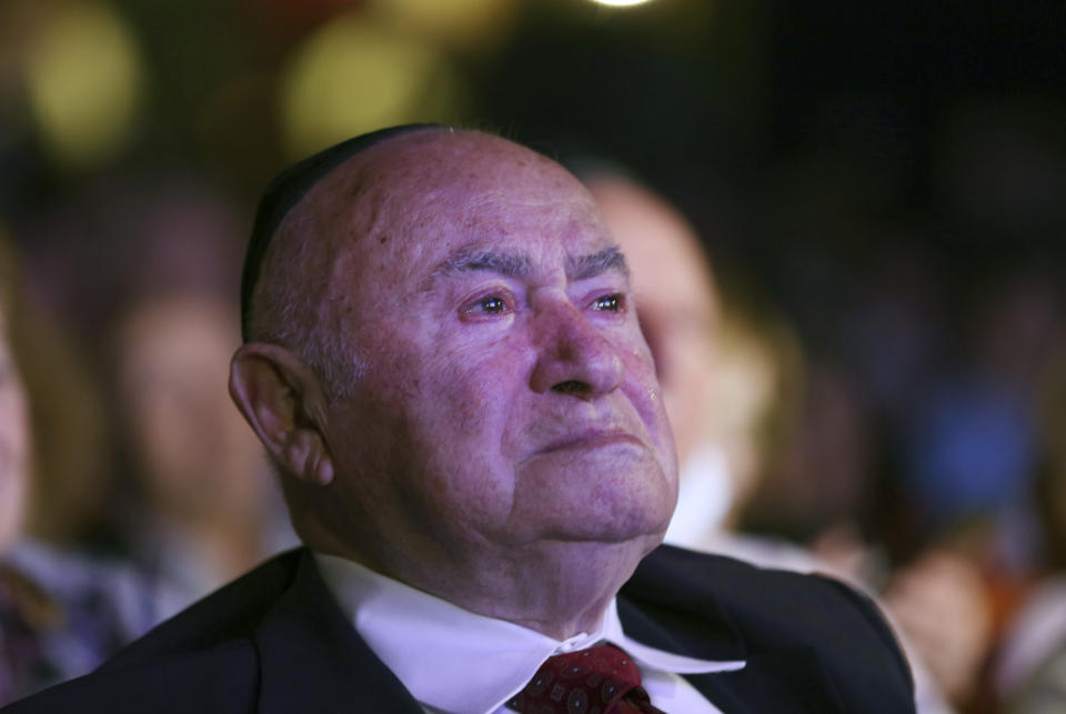 David Einhorn, 95, sheds a tear as he watches Orthodox Jewish singer Yaakov Shwekey perform at an event held to honor him and dozens of other Holocaust survivors, Monday, June 14, 2021, at the Yeshivah of Flatbush theater at Joel Braverman High School in the Brooklyn borough of New York. It was the first large gathering for New York-area Holocaust survivors after more than a year of isolation due to the coronavirus pandemic. (AP Photo/Jessie Wardarski)