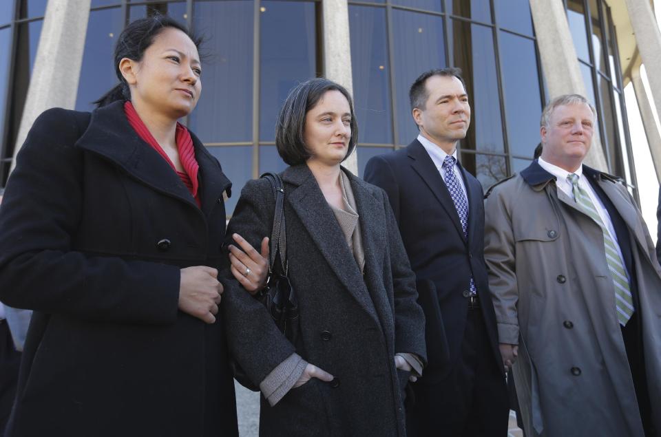 Couples Cleopatra De Leon, left, and partner, Nicole Dimetman, second from left, and Victor Holmes and partner Mark Phariss, right, talk with the media after as they leave the U.S. Federal Courthouse, Wednesday, Feb. 12, 2014, in San Antonio. The two homosexual couples are challenging Texas' ban on same-sex marriage and have taken their case to federal court. (AP Photo/Eric Gay)