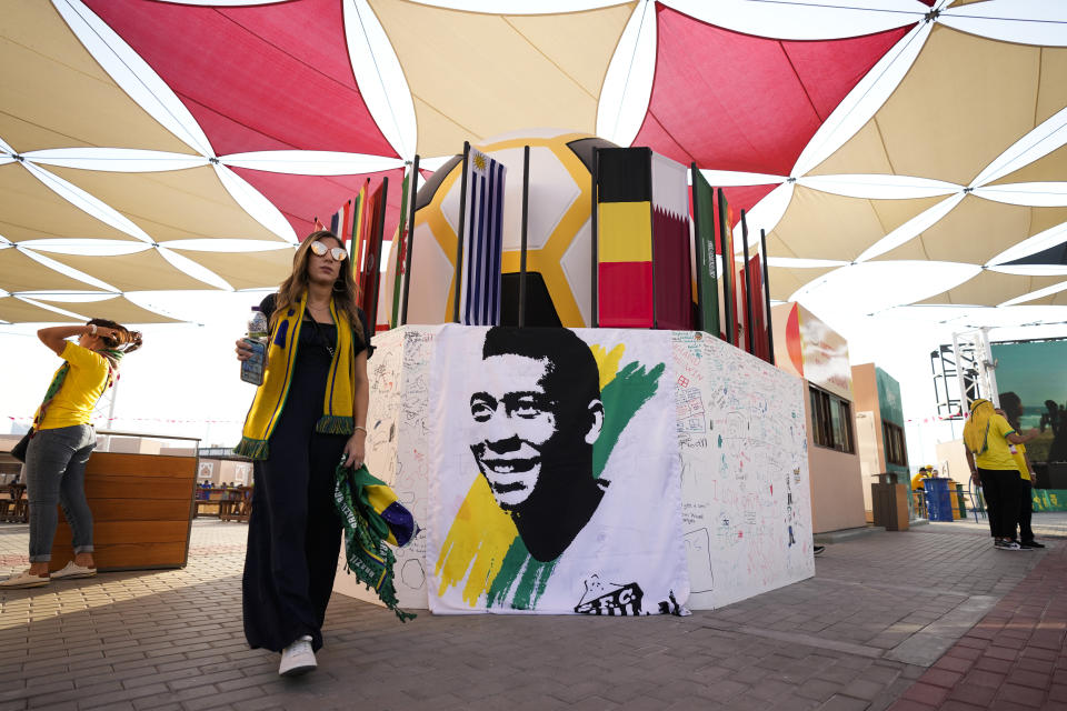 A portrait of Pelé is displayed at a Brazilian fan party before the the World Cup round of 16 soccer match between Brazil and South Korea, in Doha, Dec. 5, 2022. The 82-year-old Pelé remained in a hospital in San Paulo recovering from a respiratory infection that was aggravated by COVID-19, but the news coming from Brazil early Monday was good. (AP Photo/Ashley Landis)