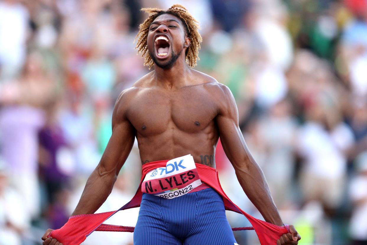 Noah Lyles celebrates winning gold in the men's 200m.