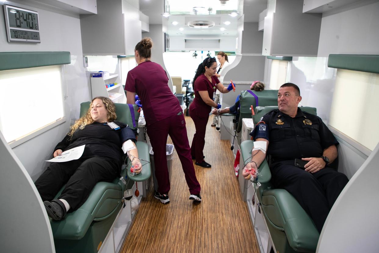 Taylor Smith, left, who works in the Lee Memorial emergency department, and acting captain Shawn Yates of the Fort Myers Police Department give blood on Tuesday, July 25, 2023, as a part of the 5th Annual Officer Adam Jobbers-Miller Blood Drive. The event runs from 8 am to 4:30 pm through Thursday, July 27. On Tuesday and Wednesday the blood drive is at Lee Memorial Hospital and the Thursday blood drive is at the Fort Myers Police Department.