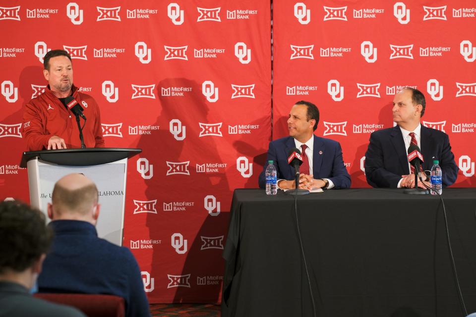 Interim OU football coach Bob Stoops (left) talks during a news conference Monday in Norman, while OU President Joseph Harroz and athletic director Joe Castiglione listen.