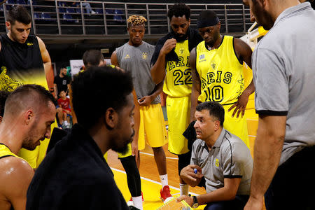 Congolese basketball player Christ Wamba (C-back) listens to instructions of Aris BC coach Vangelis Angelou (bottom-R) during a friendly game between Aris Thessaloniki BC and Istanbul BB at the Alexandreio Melathron Nick Galis Hall in Thessaloniki, Greece, September 12, 2018. REUTERS/Alkis Konstantinidis