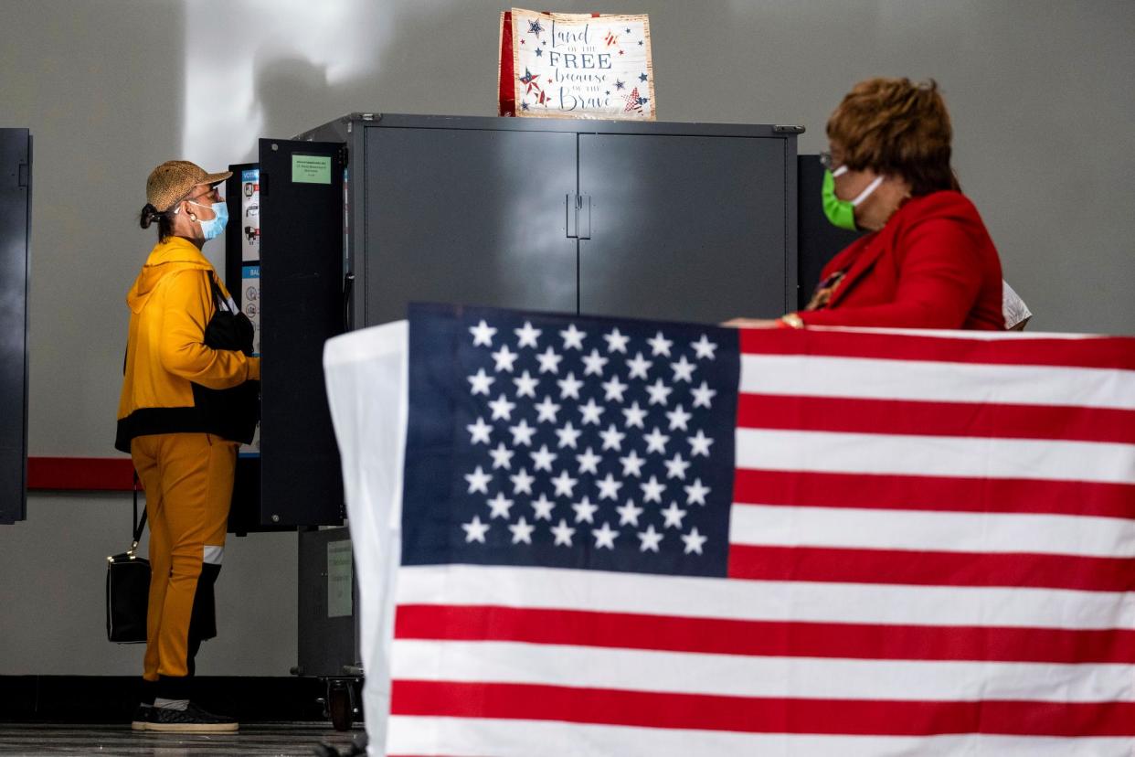 <span>A voter casts a ballot on the first day of early voting in Atlanta on 17 October 2022.</span><span>Photograph: Ben Gray/AP</span>