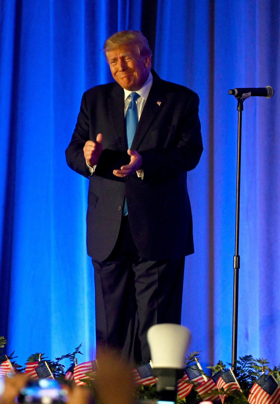 Former President Donald Trump takes the stage to speak at the Lee County Republican dinner in Fort Myers Friday.