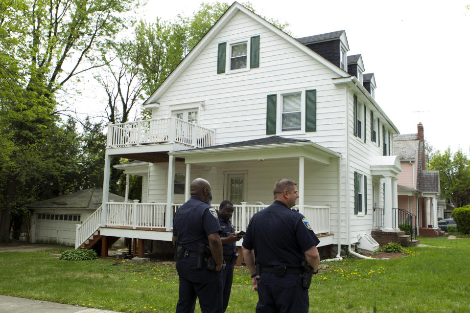 Baltimore police officers stand outside the house of Baltimore Mayor Catherine Pugh in Baltimore, MD., Thursday, April 25, 2019. Agents with the FBI and IRS are gathering evidence inside the two homes of Pugh and also in City Hall. (AP Photo/Jose Luis Magana)