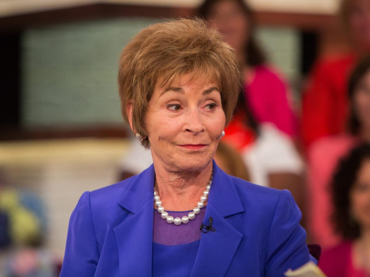 Judge Judy Sheindlin in a blue outfit with a pearl necklace.