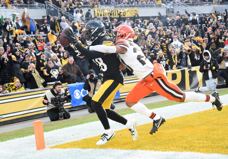 Pittsburgh Steelers wide receiver George Pickens catches a pass for a two point conversion as Cleveland Browns cornerback Greg Newsome II applies coverage during the team's January 2023 matchup.