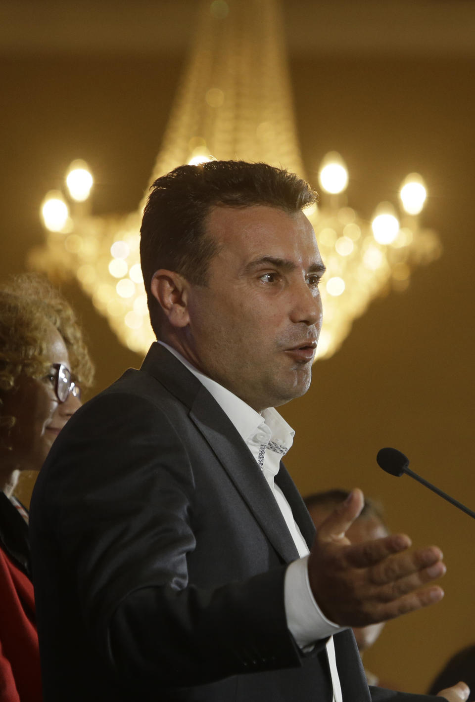 Macedonia's Prime Minister Zoran Zaev talks to members of the media during a news conference about the referendum in Skopje, Macedonia, late Sunday, Sept. 30, 2018. Zaev has described the crucial referendum on changing the small European country's name to North Macedonia and thereby pave the way to NATO membership as a clear success, despite lower than hoped for voter turnout. Zaev said he had no intention of resigning as the "vast majority" of those who voted Sunday approved the name change. (AP Photo/Boris Grdanoski)