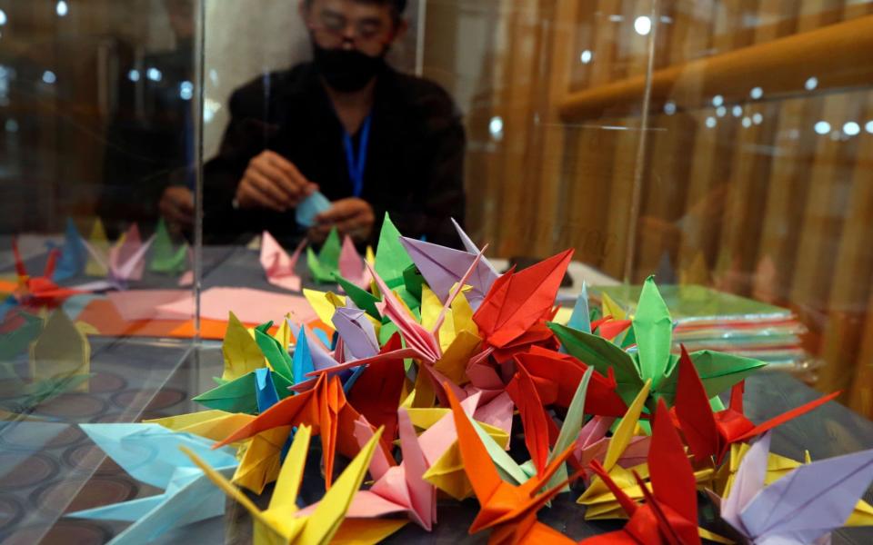 Visitors and mourners have brought offerings of Sadako origami paper cranes to mark the event - RUNGROJ YONGRIT/EPA-EFE/Shutterstock /Shutterstock