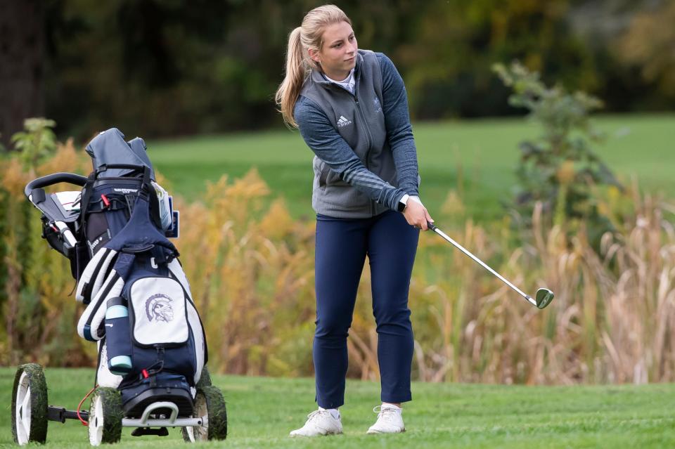 McDowell's Alexis Marsh watches her shot roll toward the green at hole No. 2 during the PIAA Class 3A girls team golf championship at Penn State University's Blue Course on Wednesday.