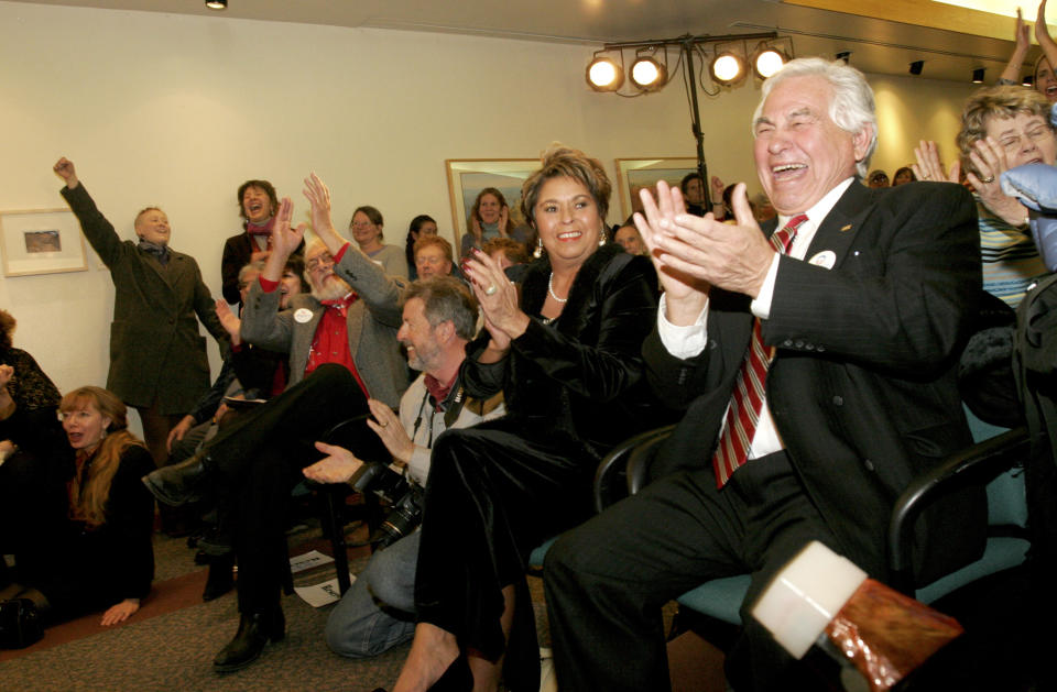 FILE - Jerry Apodaca, right, laughs while listening to Senator Ted Kennedy speak at a community college in Santa Fe, New Mexico in 2008. Apodaca, a Democrat who became New Mexico's first Hispanic governor in 54 years when he took office in 1975, died at his home in Santa Fe on Wednesday, April 26, 2023, after what may have been a stroke, his son Jeff Apodaca said. He was 88. (Jane Phillips/Santa Fe New Mexican via AP, File)