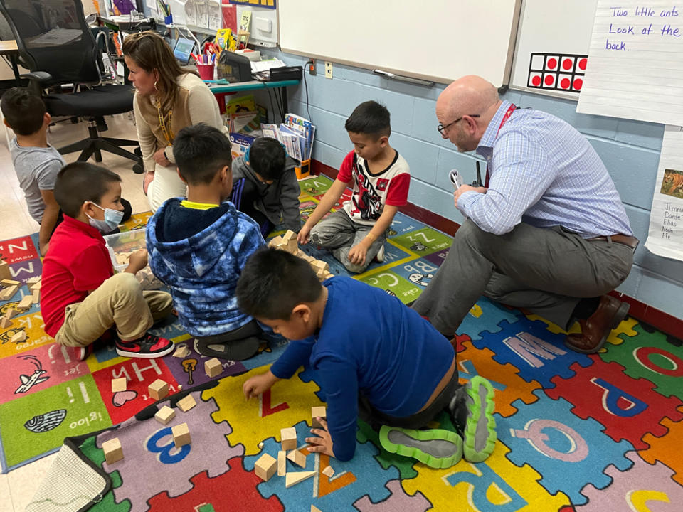  Principal Buddy Comet chats with young learners as the build block structures. (Asher Lehrer-Small)