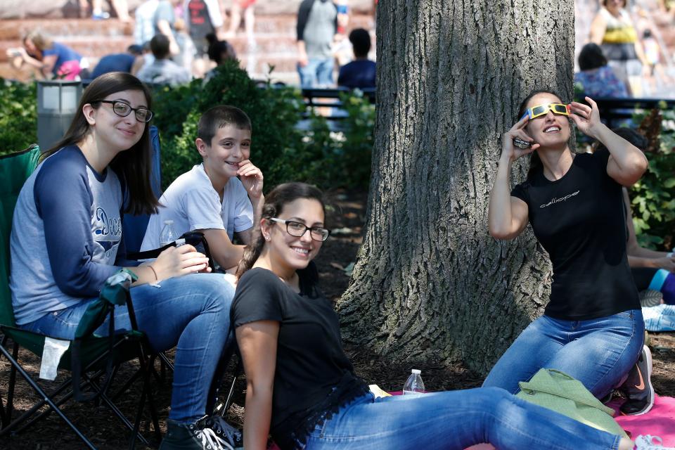 From left: Nancy, Thomas, Rhonda and Alia Nassar, view the total solar eclipse at a watch party sponsored by The Enquirer on Aug. 21, 2017, at Washington Park.