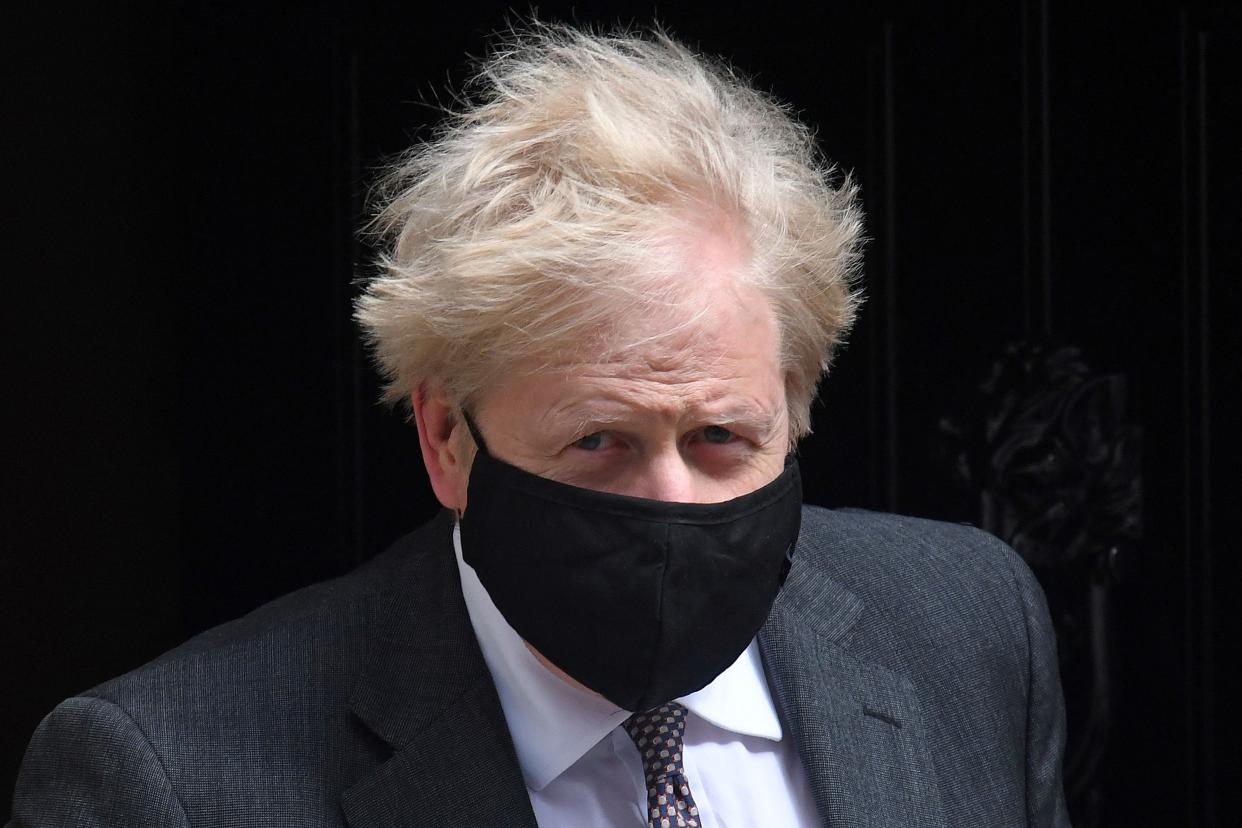 Britain's Prime Minister Boris Johnson, wearing a face mask to combat the spread of the novel coronavirus, leaves 10 Downing Street in central London on April 21, 2021, to take part in the weekly session of Prime Minister's Questions (PMQs) at the House of Commons. (Photo by DANIEL LEAL-OLIVAS / AFP) (Photo by DANIEL LEAL-OLIVAS/AFP via Getty Images)