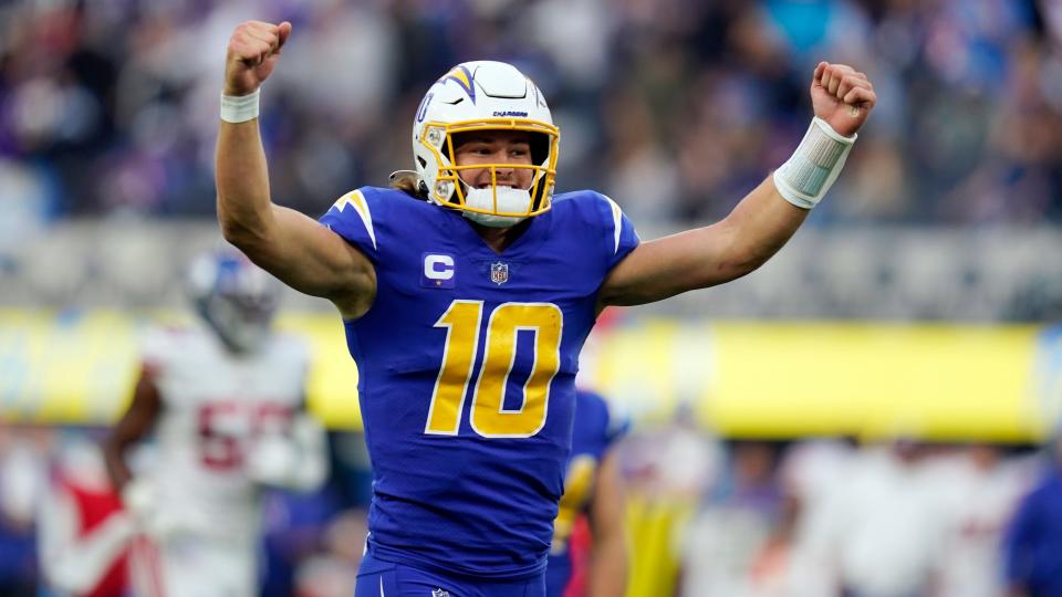 Los Angeles Chargers quarterback Justin Herbert reacts after throwing a touchdown pass during an NFL football game against the New York Giants in December 2021 in Inglewood, California. (AP Photo/Gregory Bull)