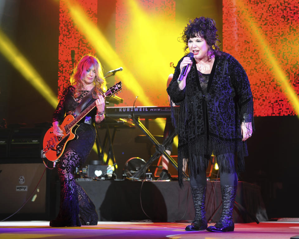 FILE - Nancy Wilson, left, and Ann Wilson of Heart perform on opening night of the Heartbreaker Tour at the Cruzan Amphitheater in West Palm Beach, Fla., June 17, 2013. Ann Wilson, lead singer of rock band Heart, says she has cancer. The band is postponing the remaining shows on its Royal Flush Tour. Wilson said in a statement Tuesday that she underwent a surgery to remove a cancerous growth and is recovering steadily, but that her doctors urged her to undergo preventive chemotherapy and take time off from performing. (Photo by Jeff Daly/Invision/AP, File)