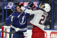 Tampa Bay Lightning's Ryan McDonagh, left, and Columbus Blue Jackets' Josh Dunne engage during the first period of an NHL hockey game Thursday, April 22, 2021, in Tampa, Fla. (AP Photo/Mike Carlson)