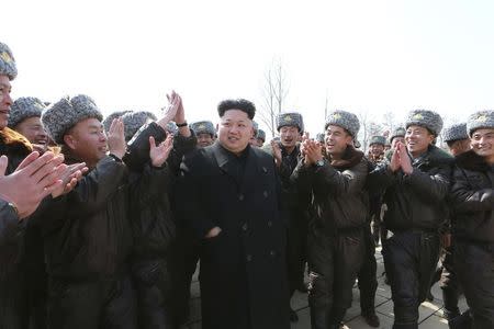 North Korean leader Kim Jong Un (C) visits Unit 447 of the Korean People's Army (KPA) Air and Anti-Air Force honoured with the title of O Jung Hup-led 7th Regiment and plant trees with fighter pilots of the unit in this undated photo released by North Korea's Korean Central News Agency (KCNA) in Pyongyang March 3, 2015. REUTERS/KCNA