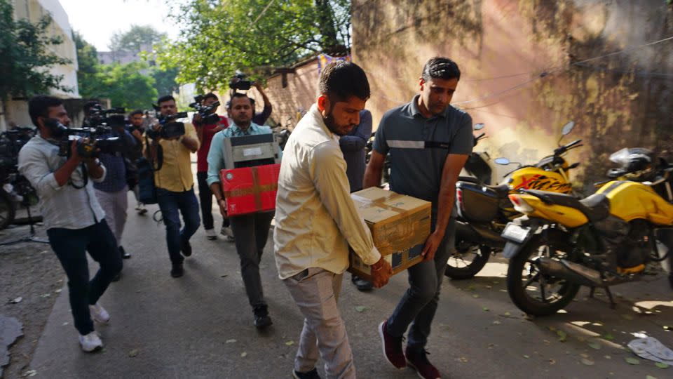 Security officers after a raid at the office of NewsClick in New Delhi, India, Tuesday, Oct. 3, 2023. - Dinesh Joshi/AP/File