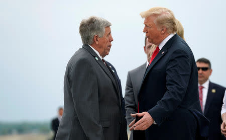 FILE PHOTO: U.S. President Donald Trump speaks with the Governor of Missouri Mike Parson as he arrives in St. Louis, Missouri, U.S., July 26, 2018. REUTERS/Joshua Roberts