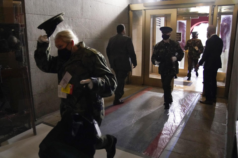 Members of the military band evacuate from the West Front of the U.S. Capitol during a rehearsal the 59th Presidential Inauguration at the U.S. Capitol in Washington, Monday, Jan. 18, 2021. (AP Photo/Andrew Harnik)