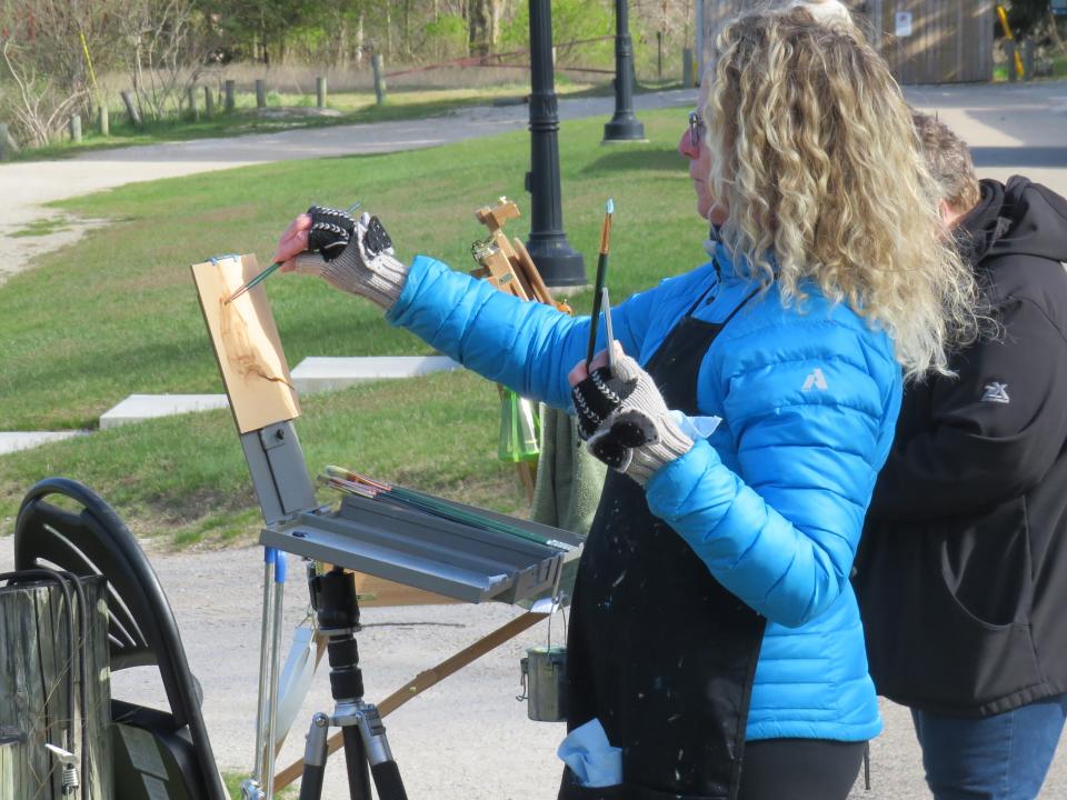 Terrie Anderson paints at the Felt Estate on Saturday, April 20.