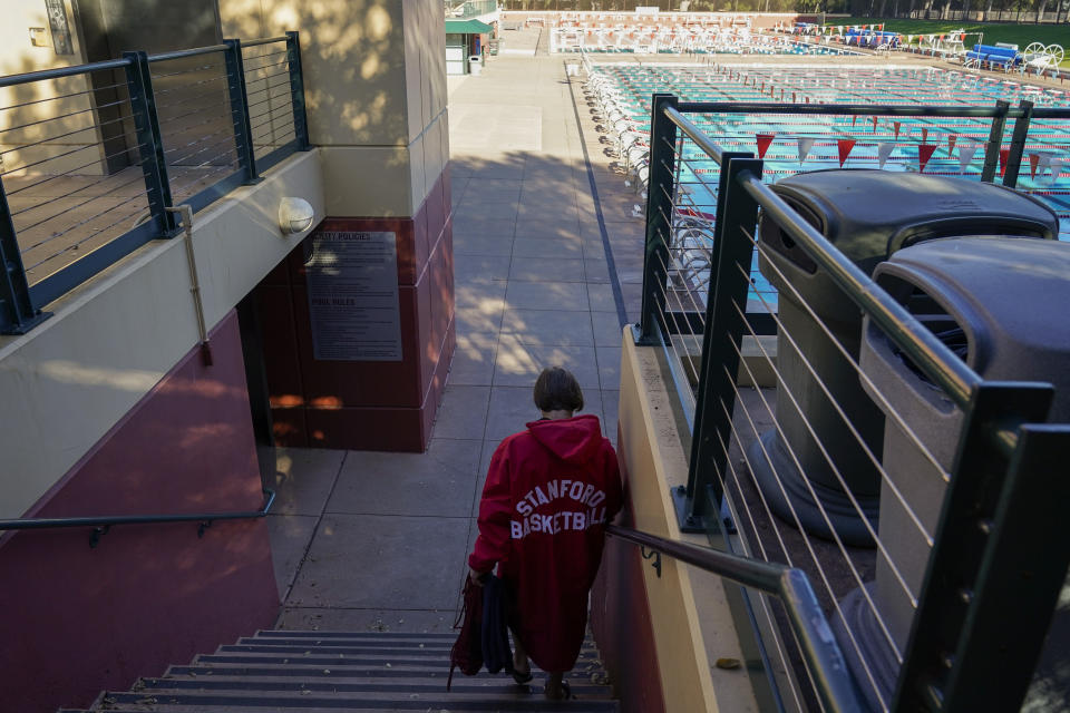 Stanford women's basketball head coach Tara VanDerveer walks to the school's Olympic-size pool for a swim in Stanford, Calif., Wednesday, Nov. 16, 2022. Regular swimming is one more thing VanDerveer squeezes into her jam-packed days three times a week to keep mentally and physically ready as she begins her 37th season on The Farm and 44th overall as a women's head coach. (AP Photo/Godofredo A. Vásquez)