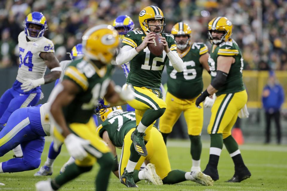 Green Bay Packers' Aaron Rodgers runs during the first half of an NFL football game against the Los Angeles Rams Sunday, Nov. 28, 2021, in Green Bay, Wis. (AP Photo/Aaron Gash)