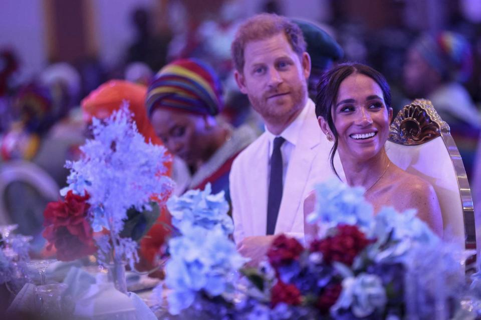 <p>KOLA SULAIMON/AFP via Getty </p> Meghan Markle and Prince Harry attend a reception in Abuja on May 11, 2024